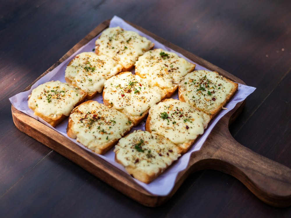 Cheesy garlic bread on a board