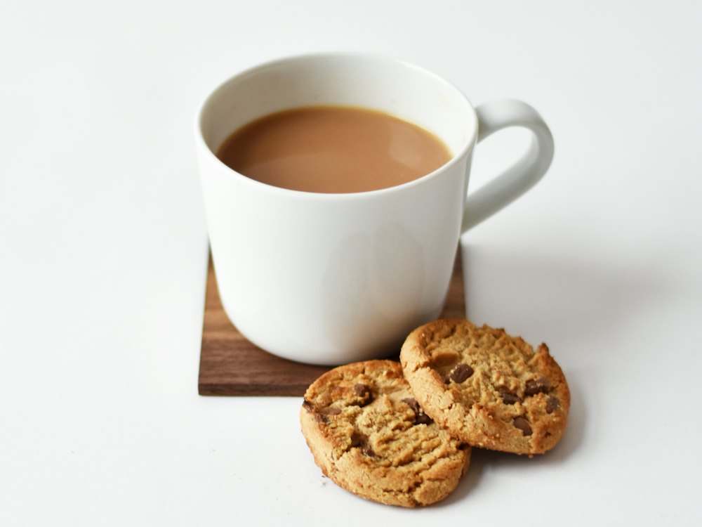 Cup of milky chai with biscuits