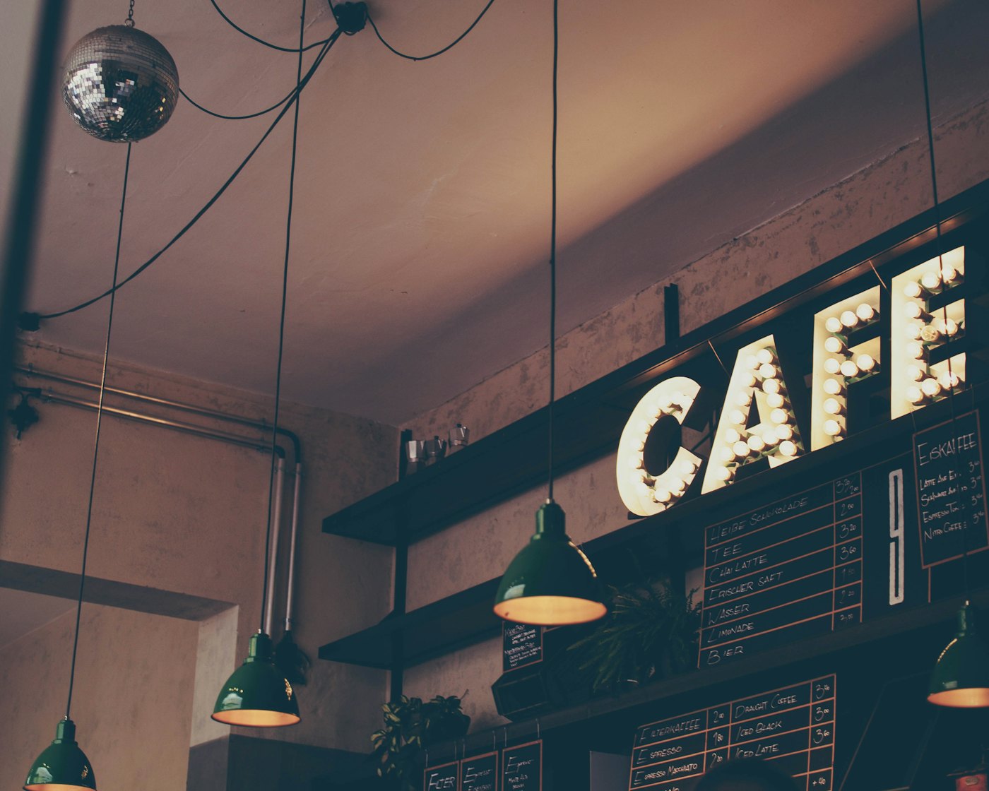 Café sign glowing in the evening