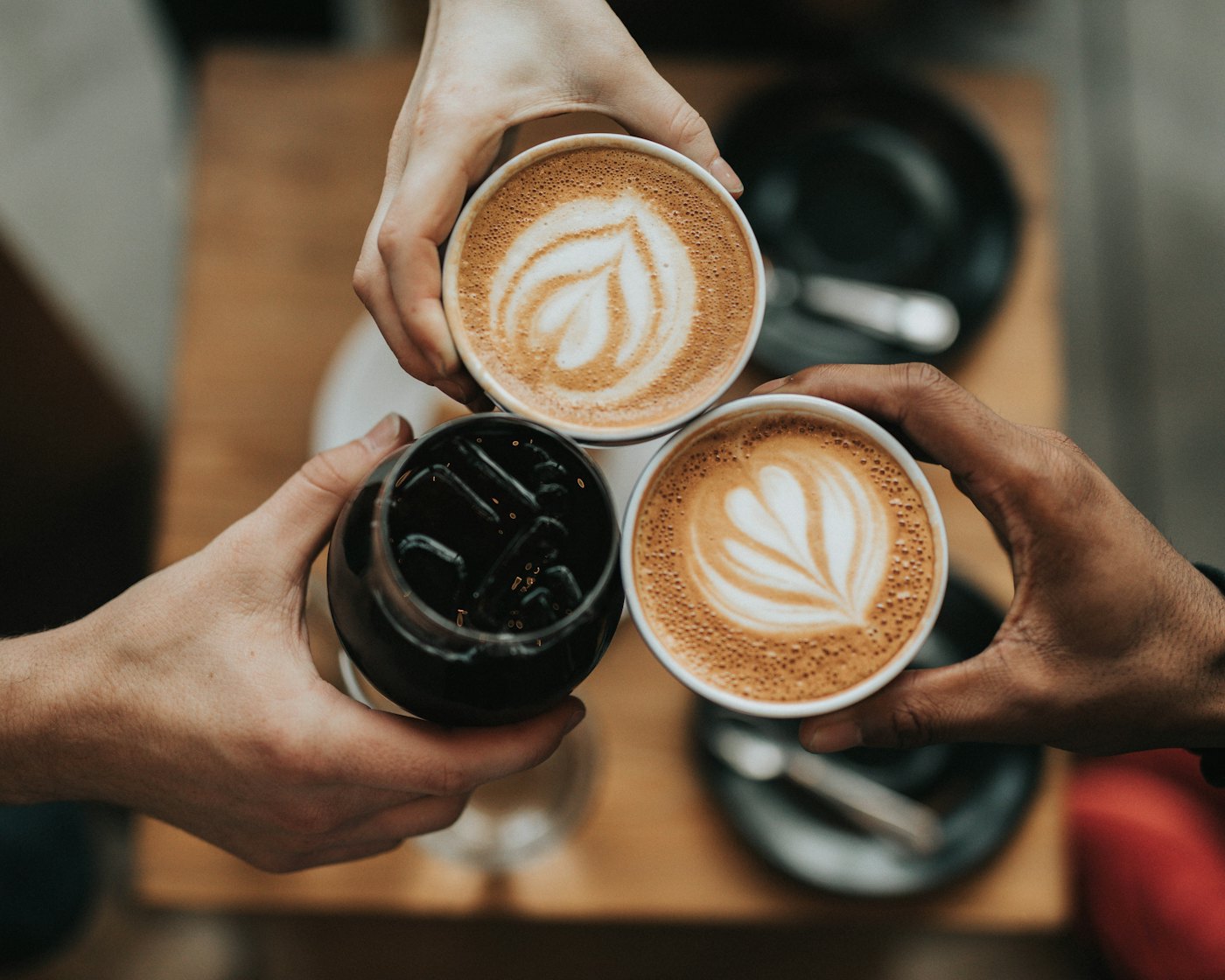 Friends raising cups of coffee